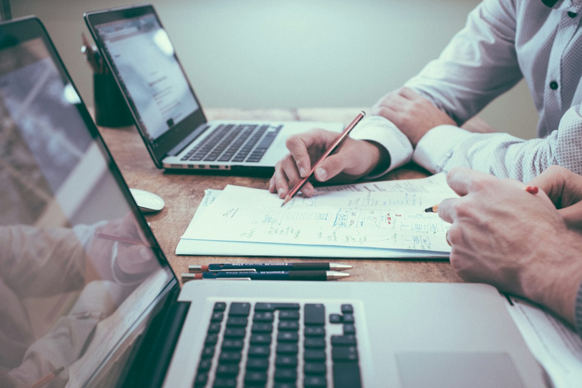 Freelancer reviewing contracts and spreadsheets at a desk